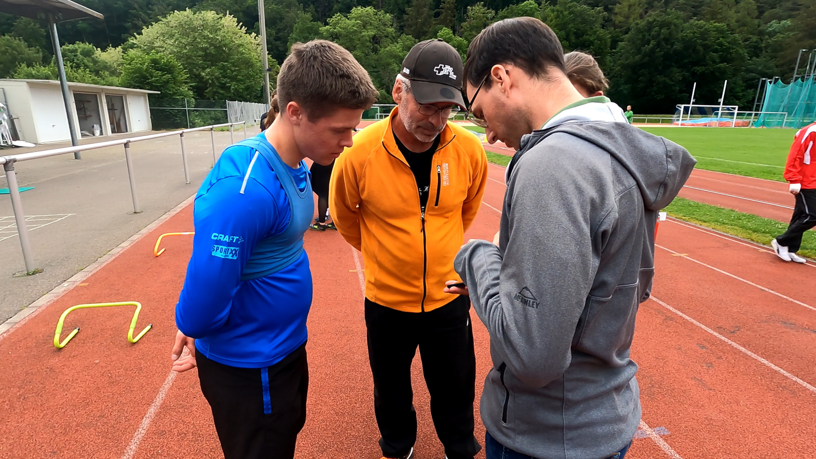 Picture giving performance feedback to athlete and coach